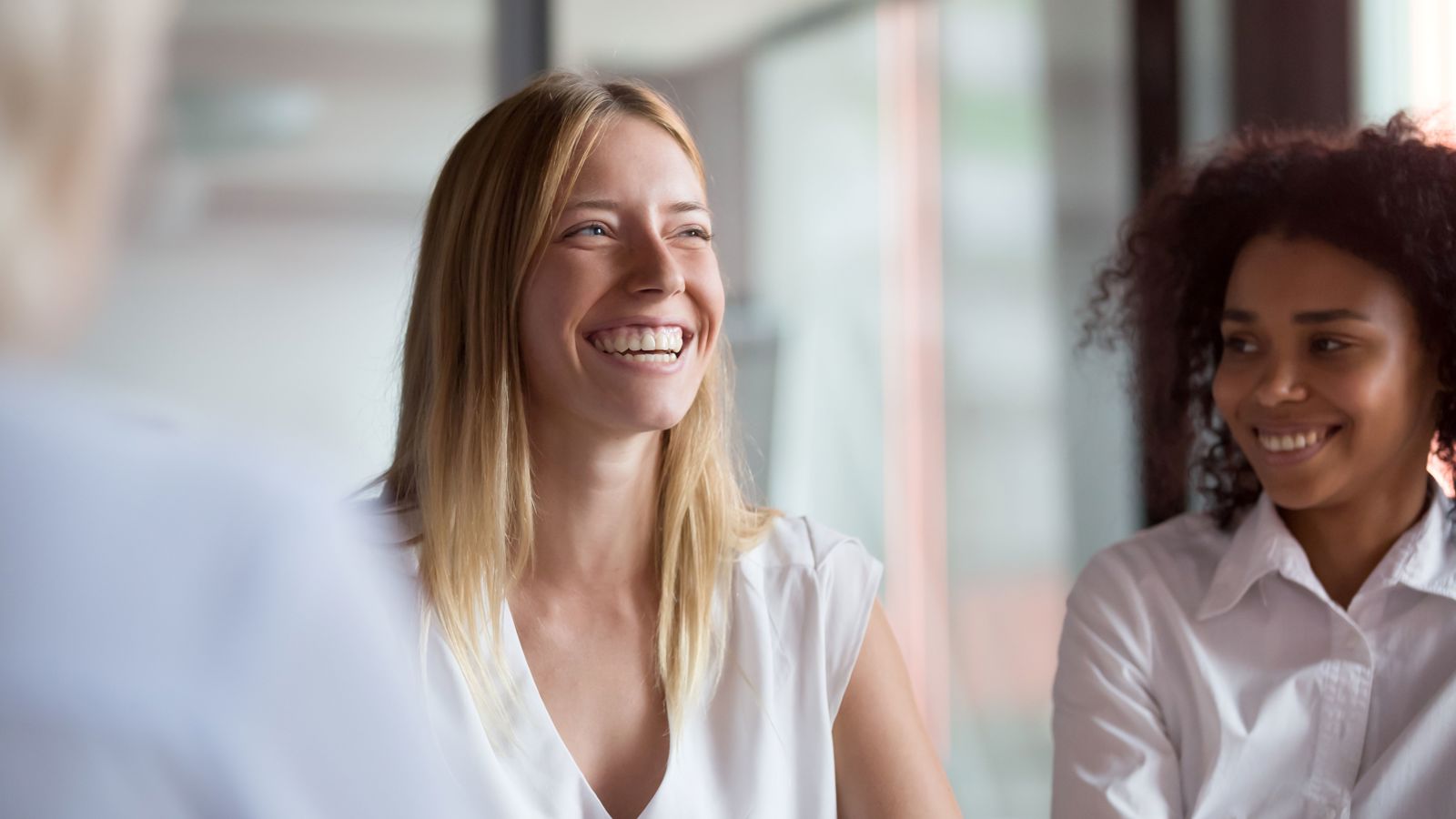 Two women smiling in a meeting situation